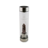 Aries Laterra Gemstone Water Bottle with Red Jasper crystal attachment inside clear glass bottle on white background.