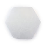 Top view of a polished selenite hexagon coaster showing its translucent white glow and natural texture on a white background.